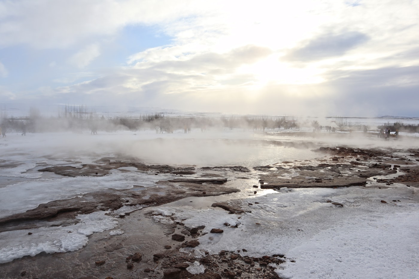 Steam drifting across a frozen geothermal plain
