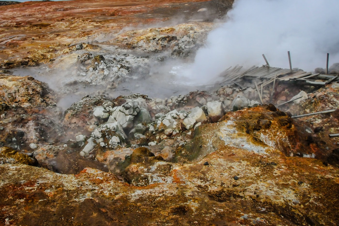 Steam vent with ochre mineral rock