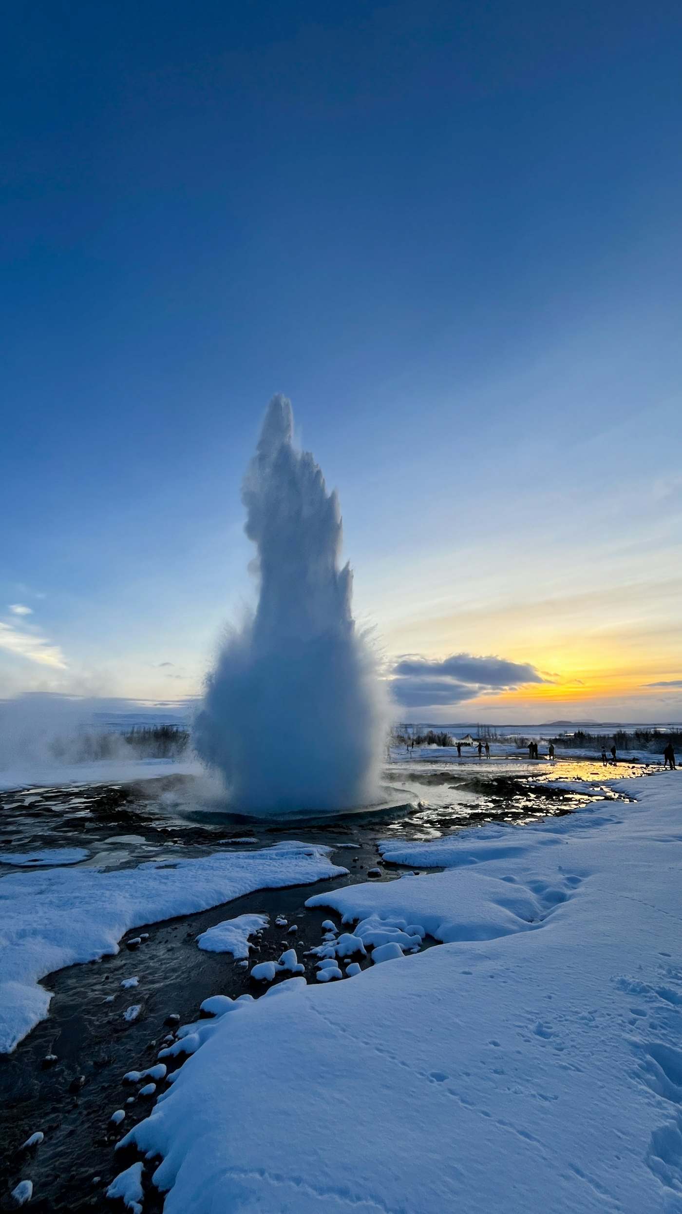 Geyser eruption at sunset